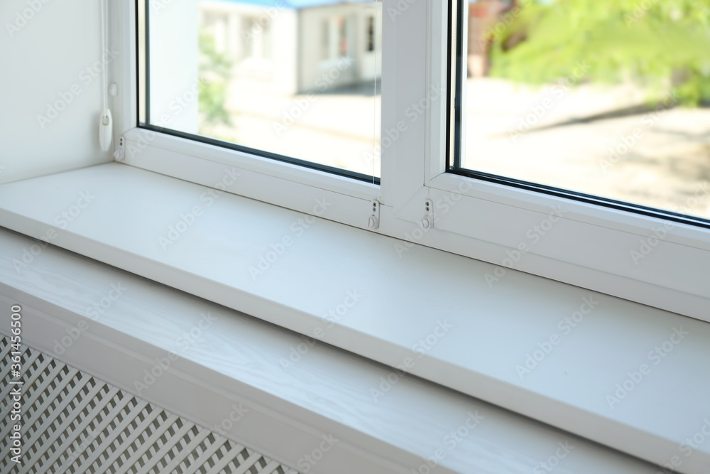 Closeup view of window with empty white sill