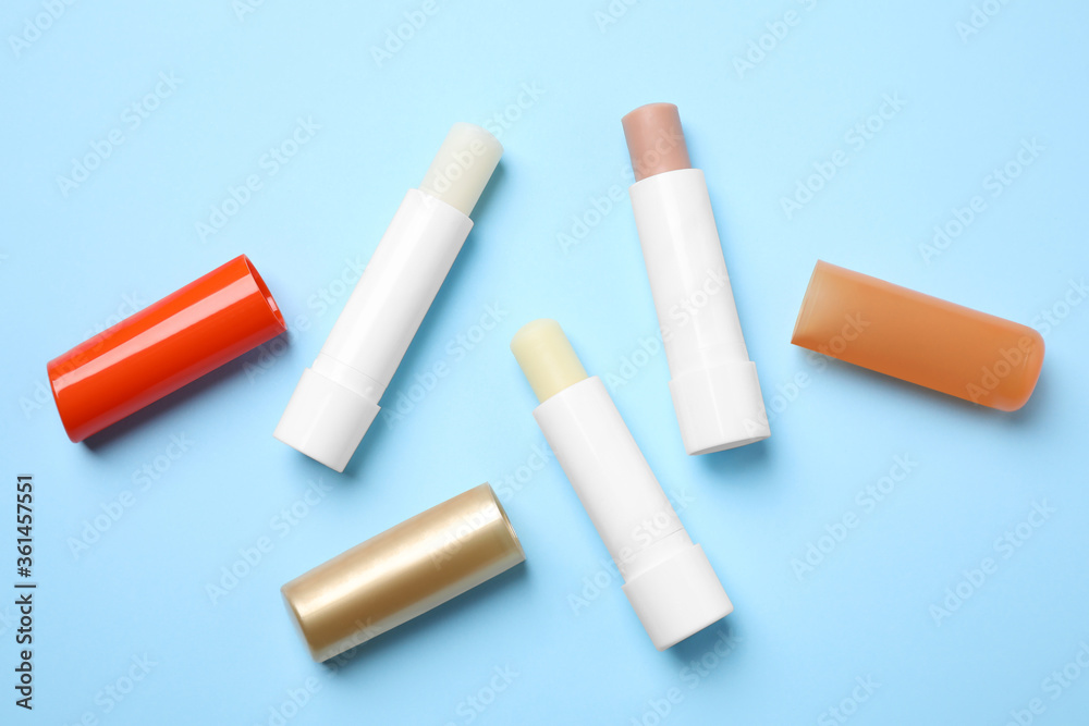 Hygienic lipsticks on light blue background, flat lay Hygienic lipsticks on light blue background, flat lay