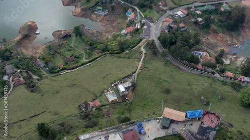 Aerial View of Houses Near River in  Guatapé Columbia on a Partly Cloudy Day photo