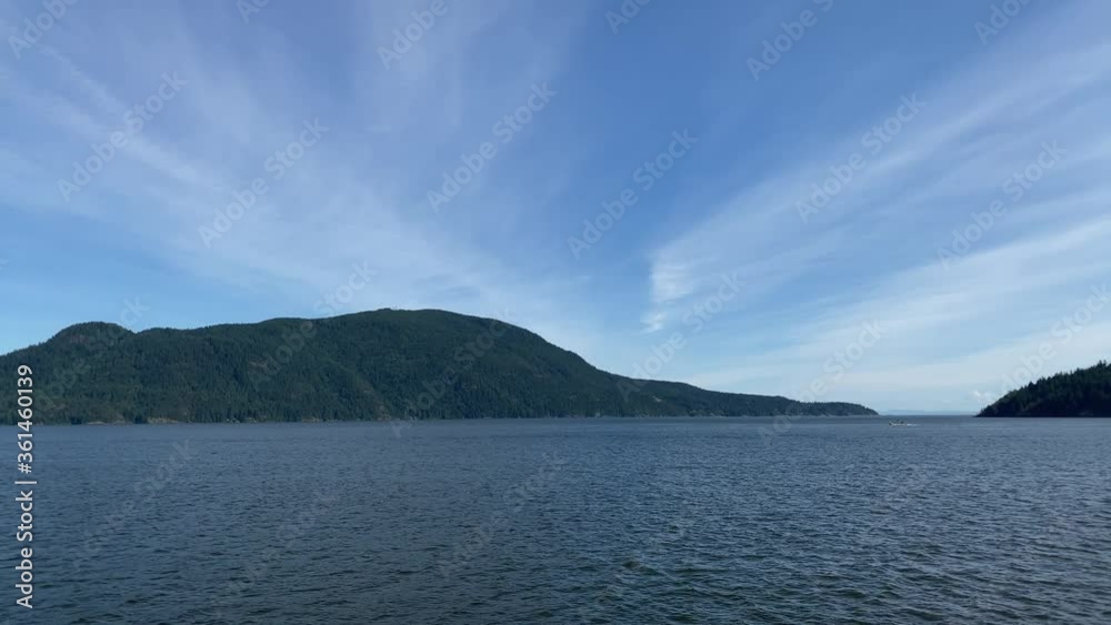Ocean view with mountains, blue sky and white clouds at summer day. Ocean view with mountains, blue sky and white clouds at summer day.