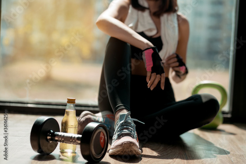 Woman exercise workout in gym fitness breaking relax after training sport with dumbbell and mineral salt bottles healthy lifestyle bodybuilding, Athlete builder muscles lifestyle.