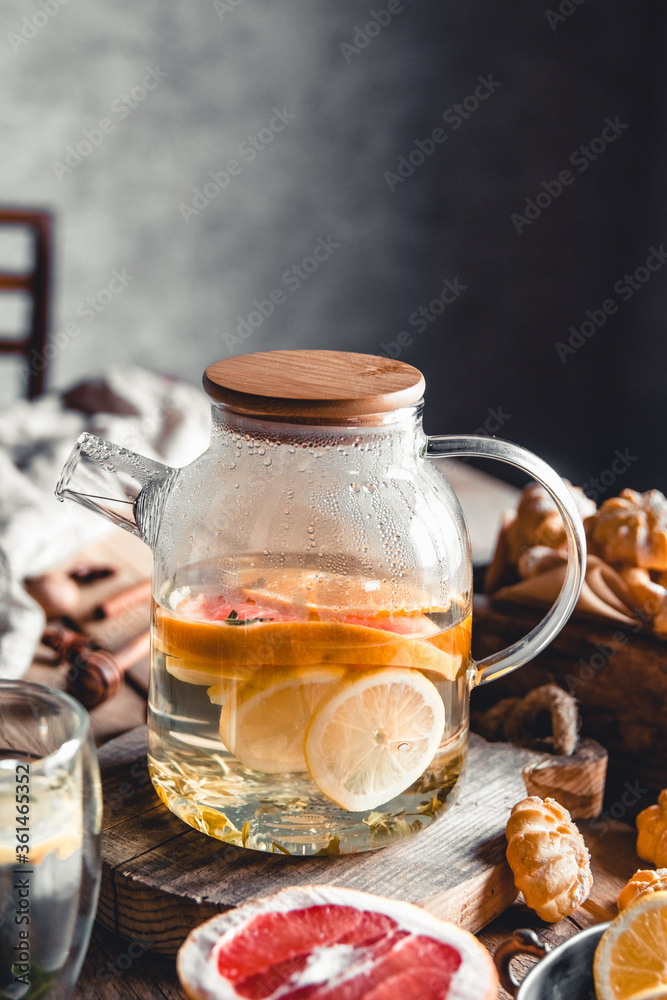 Hot tea with slices of fresh grapefruit on wooden tablet. Healthy drink, Eco, vegan Hot tea with slices of fresh grapefruit on wooden tablet. Healthy drink, Eco, vegan