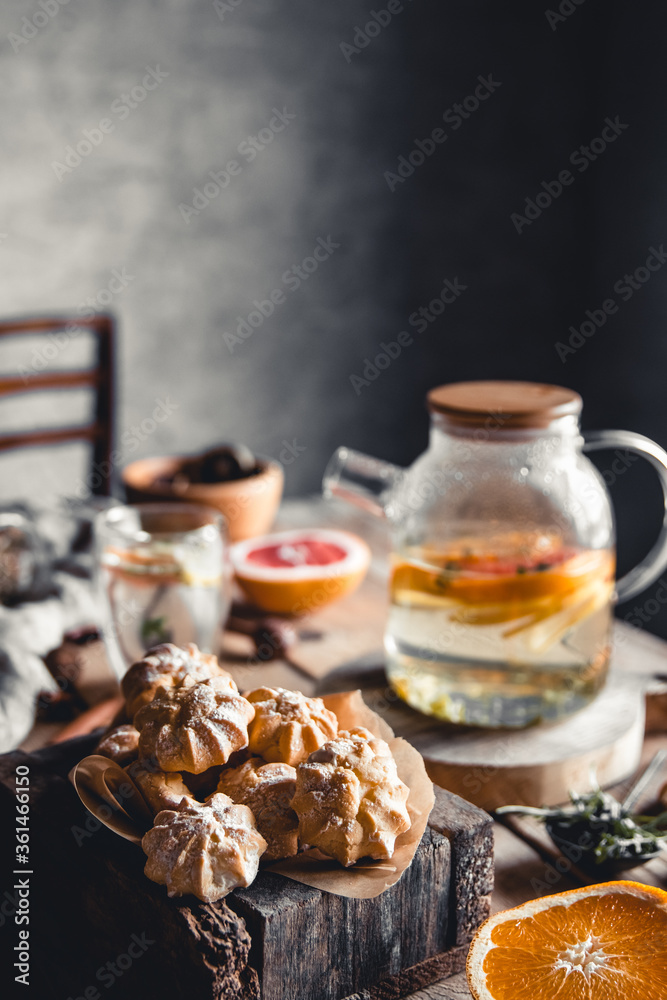 Tasty cakes with Hot tea with slices of fresh grapefruit on wooden tablet. Healthy drink, Eco, vegan Tasty cakes with Hot tea with slices of fresh grapefruit on wooden tablet. Healthy drink, Eco, vegan