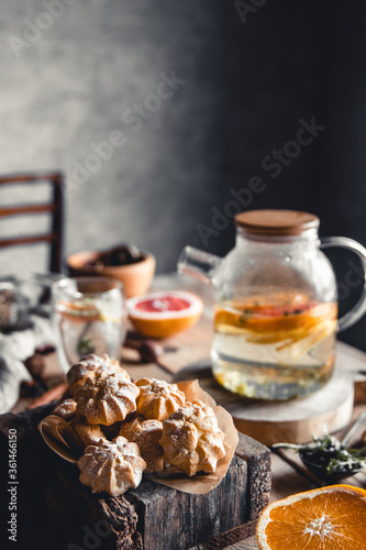 Tasty cakes with Hot tea with slices of fresh grapefruit on wooden tablet. Healthy drink, Eco, vegan © Svetlana