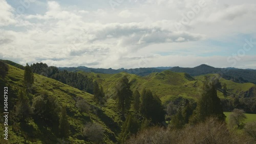 Grassy hills along Hwy 4 and the Mangawhero River on the North Island of New Zealand - Cloudy- Spring// Static Shot photo