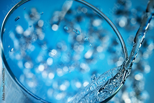 Mineral water is poured into a glass.