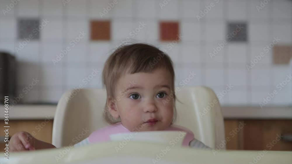 portrait of a child who eats baby food with his hands. my face is smeared with food portrait of a child who eats baby food with his hands. my face is smeared with food