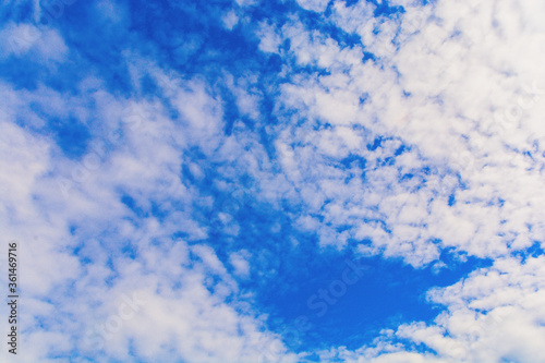 White fluffy cirrus clouds in the blue sky