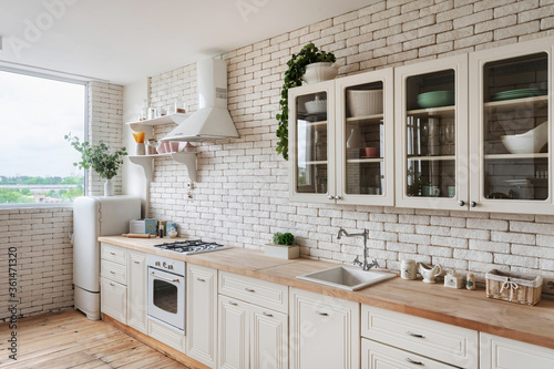 White kitchen in apartment with modern interior