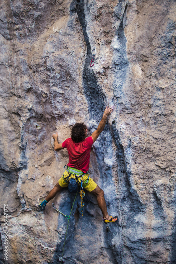 A strong man climbs a rock, Rock climbing in Turkey.