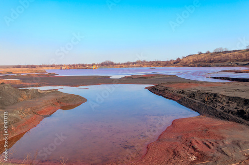 Fototapeta Naklejka Na Ścianę i Meble -  Technical settler of industrial water of mining industry in Kryvyi Rih, Ukraine. Red water polluted with iron ore waste