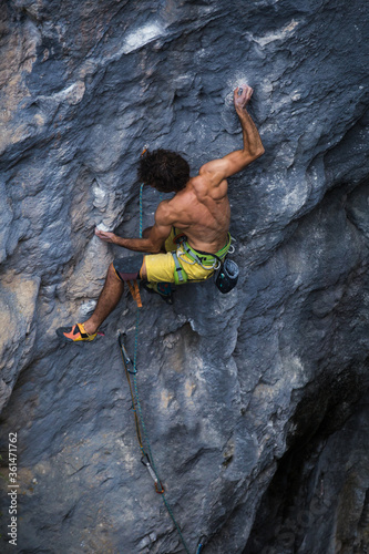 Fototapeta Naklejka Na Ścianę i Meble -  A strong man climbs a rock, Rock climbing in Turkey.