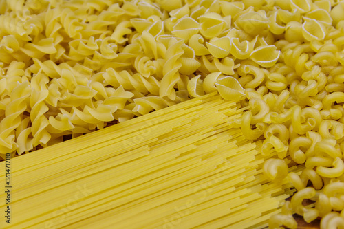 Variety of types and shapes of raw italian pasta. Close-up