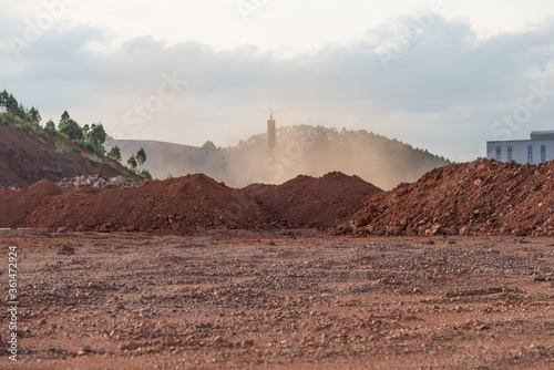 Slika na platnu Dirt piles and dust from the wind at the construction site