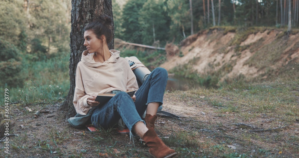 woman reading book on nature woman reading book on nature