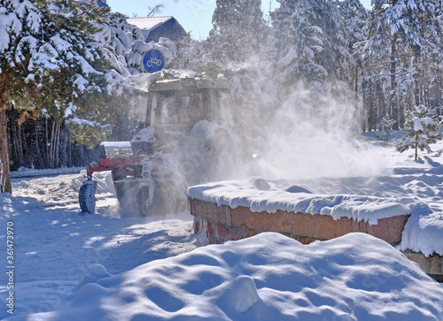 Snow removal in a city park in the winter season