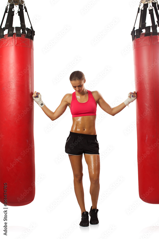 Portrait brunette boxing girl in boxing gloves and body hitting pear