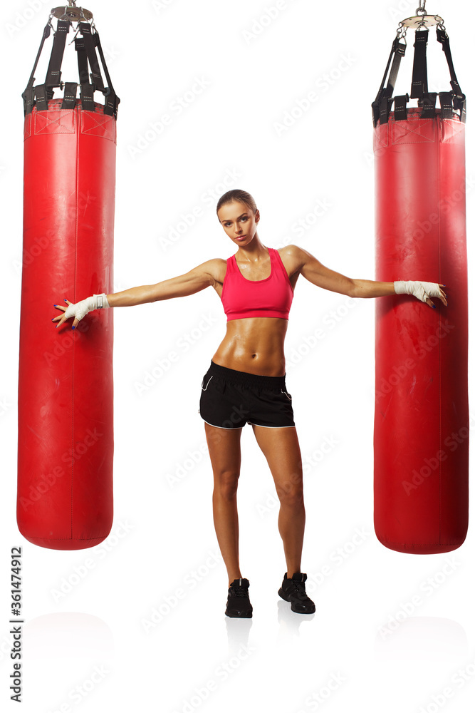 Portrait brunette boxing girl in boxing gloves and body hitting pear