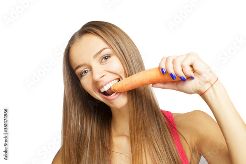 Beautiful sexy young woman eating carrot isolated on white background