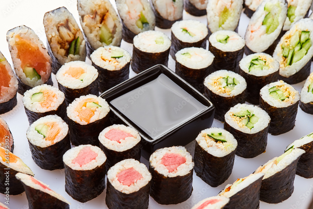 Various kinds of sushi roll set served on cutting board. Japanese food Various kinds of sushi roll set served on cutting board. Japanese food