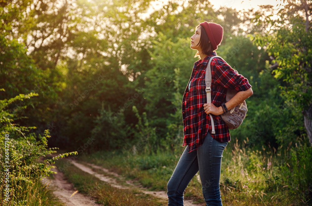 Young hipster girl enjoy sunset. Travel woman with backpack Young hipster girl enjoy sunset. Travel woman with backpack