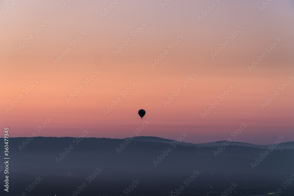 The silhouette of a hot air balloon during sunrise.