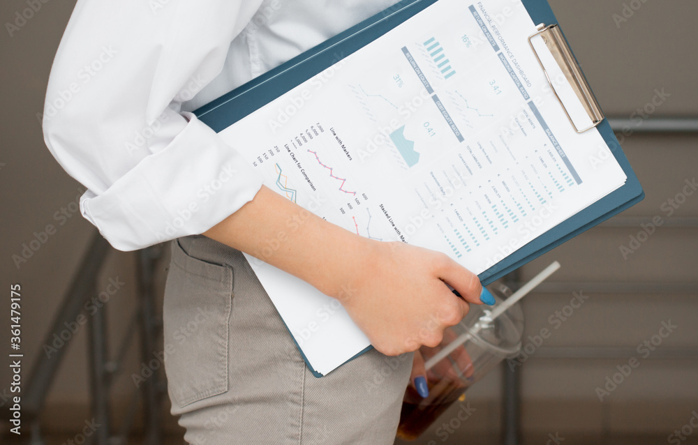 Business woman office workers holding are arranging documents of unfinished documents. Stack of business paper,document management. Businesswoman examining documents Business woman office workers holding are arranging documents of unfinished documents. Stack of business paper,document management. Businesswoman examining documents