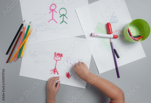 Concept of development and training of a child at home during the pandemic of coronavirus and COVID-19,Child's drawing with color pencil