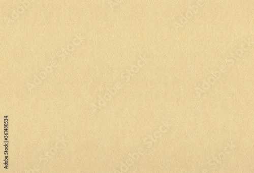 Sheet of textured light brown coloured creative paper background. Extra large highly detailed image.