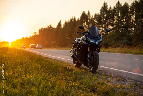 sports motorcycle at sunset road photo