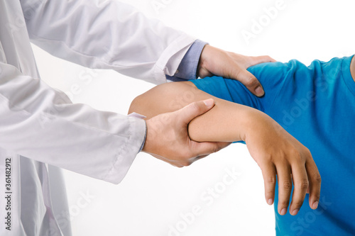 Doctor physiotherapist consulting with patient about shoulder muscle pain problems in clinic medical office.