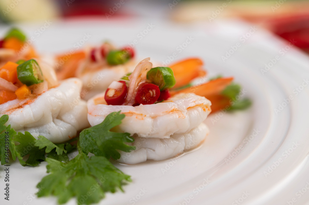 Spicy salad with shrimp on a white plate. Thai food. Spicy salad with shrimp on a white plate. Thai food.