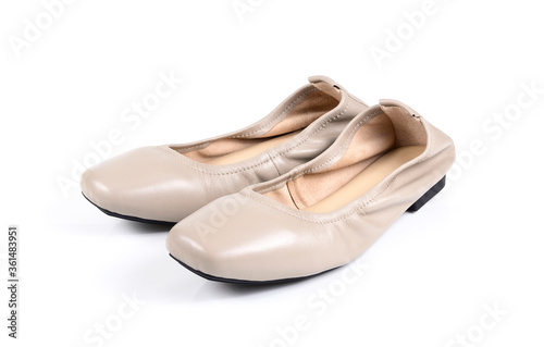 beige ladies' flat shoes on white background.