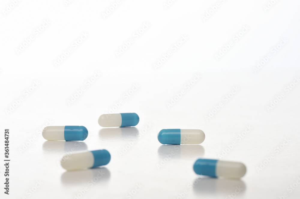 Drug capsule isolated on white background, selective focus