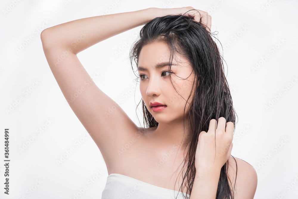 A beautiful, beautiful woman catches her messy hair. A beautiful, beautiful woman catches her messy hair.