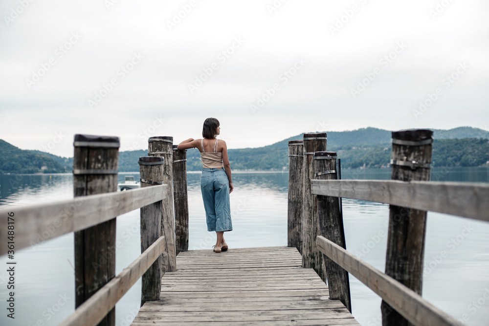 Young woman sitting near the lake