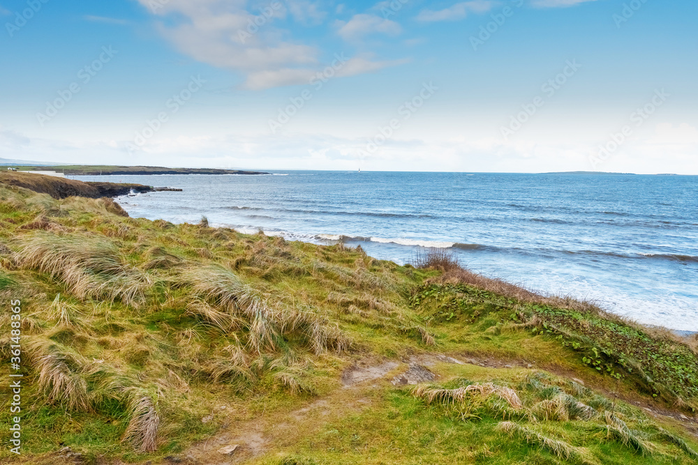 View on Atlantic ocean, Rosses point, county Sligo, Ireland, Warm sunny day, Clear blue sky, Nobody. Small footpath to the beach. View on Atlantic ocean, Rosses point, county Sligo, Ireland, Warm sunny day, Clear blue sky, Nobody. Small footpath to the beach.