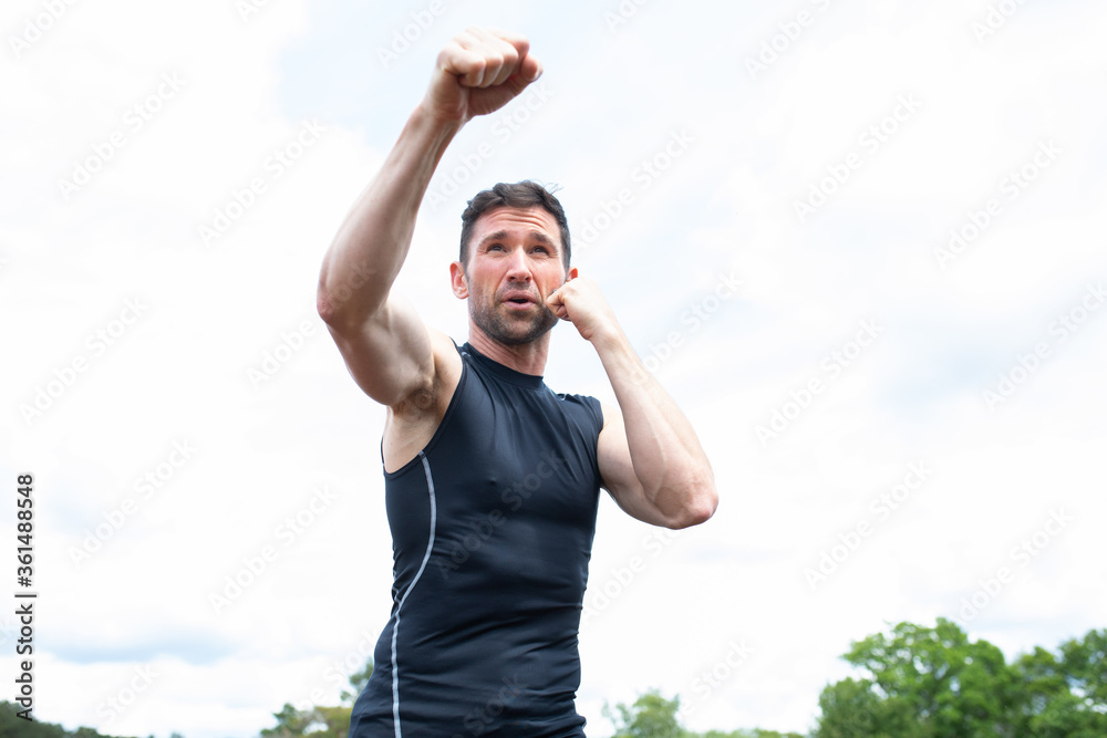 Man practicing boxing and sparing in the countryside Man practicing boxing and sparing in the countryside
