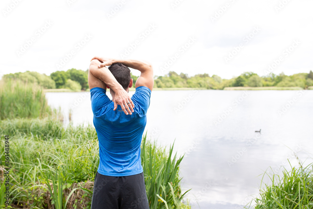 Man Stretching in countryside Man Stretching in countryside