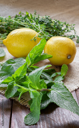 Fresh mint with a juicy lemon on the burlap.