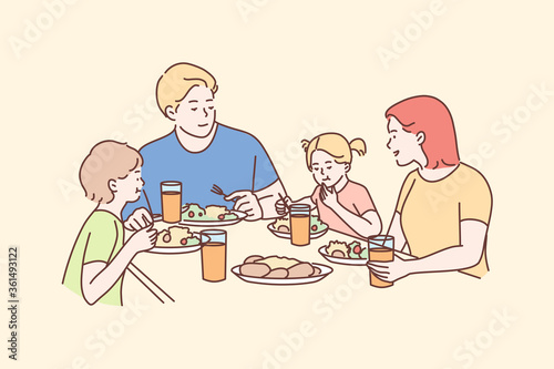 Family, meal, recreation, leisure, dinner, fatherhood, motherhood, childhood concept. Man dad woman mom children kids son daughter eating breakfast dinner lunch supper together. Fathers mothers day.