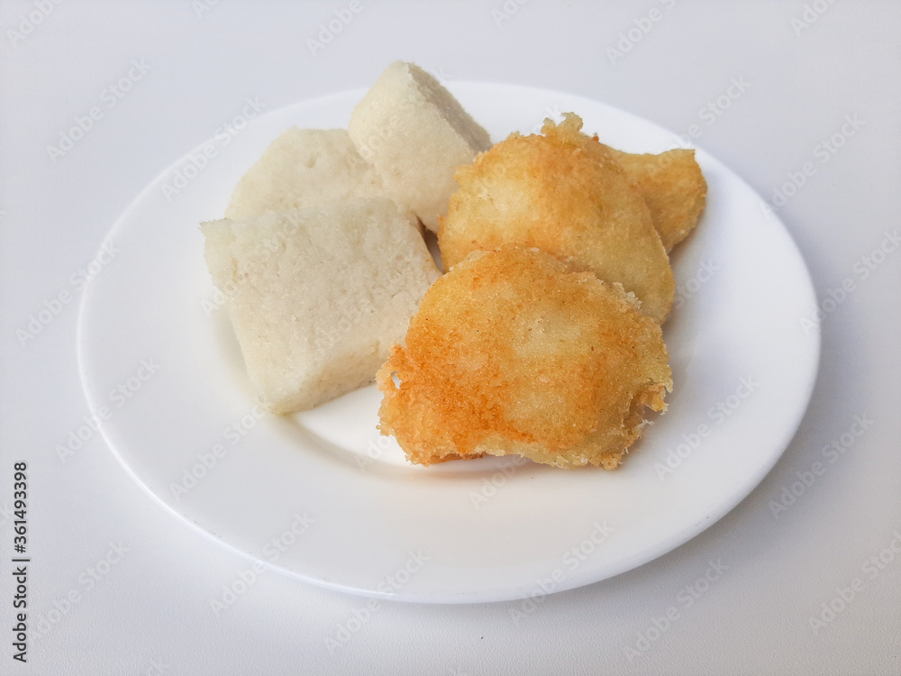 Jadah ketan, is a traditional snack from Indonesia. Made from sticky rice and grated coconut. Comparison before and after fried. On a white plate, isolated in white background