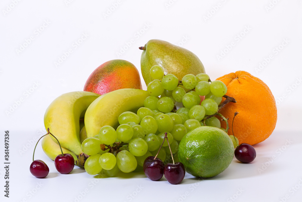 Assortment of fresh ripe exotic fruits on a light background. Healthy eating concept. Assortment of fresh ripe exotic fruits on a light background. Healthy eating concept.