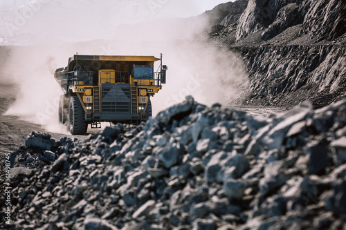 Fototapeta Career dump truck is going to the gold mining range.