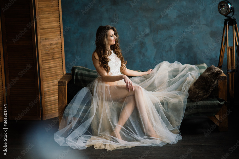 Morning of the bride. Sexy girl posing in white lace underwear. Portrait of a beautiful young female in a white underwear. Seductive woman in white linen and a peignoir. Morning of the bride. Sexy girl posing in white lace underwear. Portrait of a beautiful young female in a white underwear. Seductive woman in white linen and a peignoir.