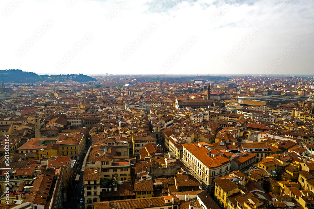 Florence, Italy. An aerial view of the city landscape seen from the bell tower of Santa Maria del Fiore church. Here you can see the train station surrounded by the typical red roofs of the town
