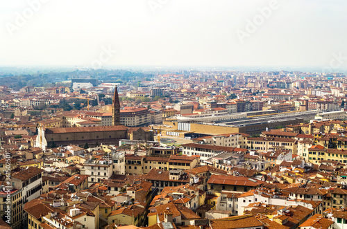 Florence, Italy. An aerial view of the city landscape seen from the bell tower of Santa Maria del Fiore church. Here you can see the train station surrounded by the typical red roofs of the town