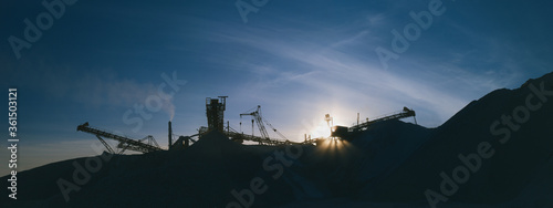 Industrial landscape. Panorama constructions of mining and processing plant on the background of the evening sky in cold colors.