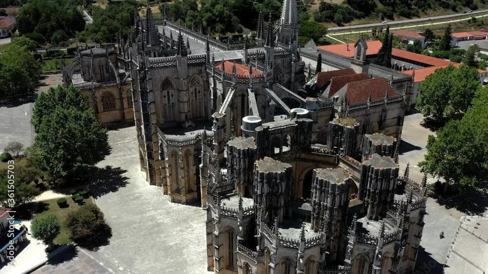 Batalha, Portugal - June, 29, 2020: 180 degrees Aerial Drone View of Batalha Monastery. Dominican convent with manueline style architecture. Batalha, Portugal - June, 29, 2020: 180 degrees Aerial Drone View of Batalha Monastery. Dominican convent with manueline style architecture.