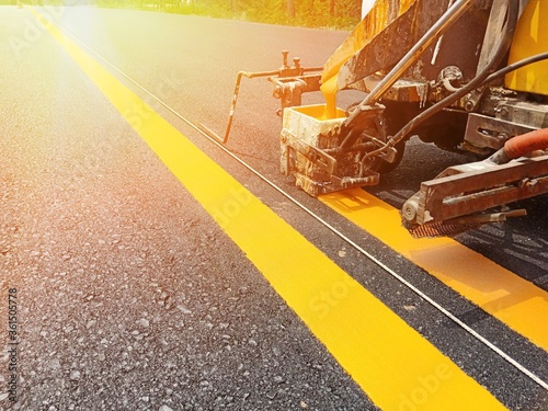 Workers are crossing a line of yellow double solid lines.